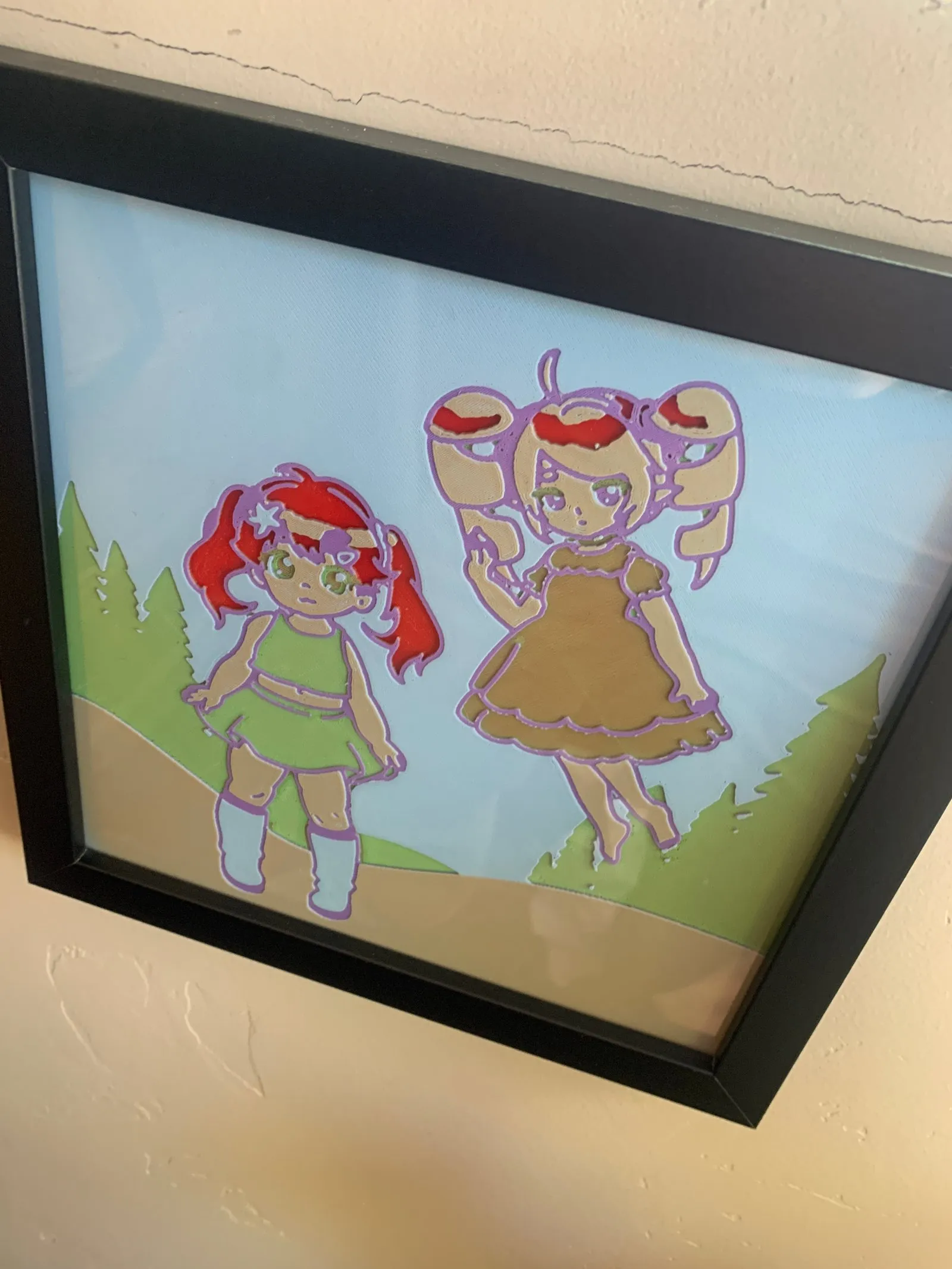 A 3D-printed framed photo of Daisy and Annie, displayed in my sewing room.