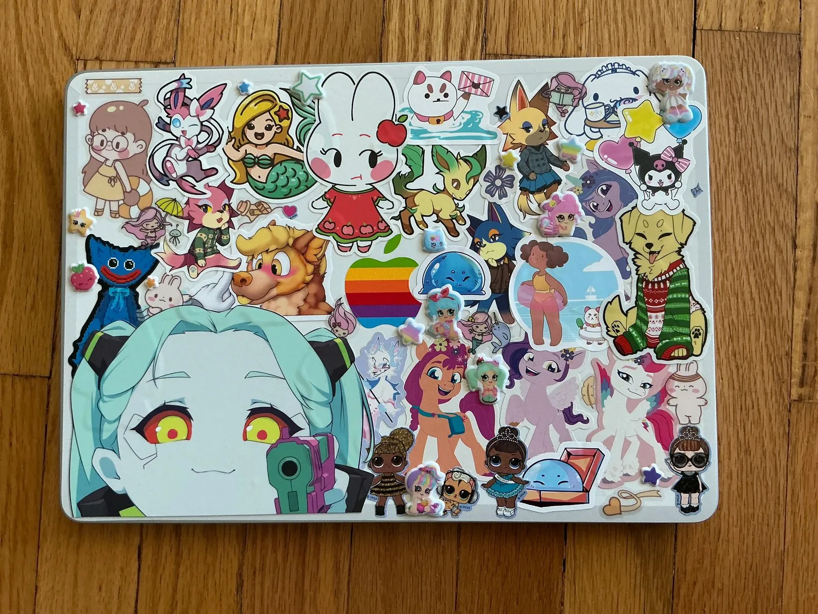 Sticker-bombed laptop covered in convention stickers.