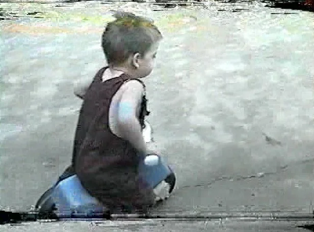 Me as a child on a tricycle in the driveway.