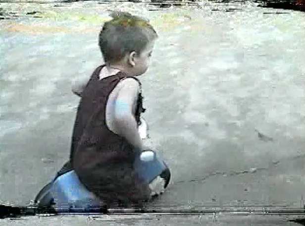 Me as a child on a tricycle in the driveway.