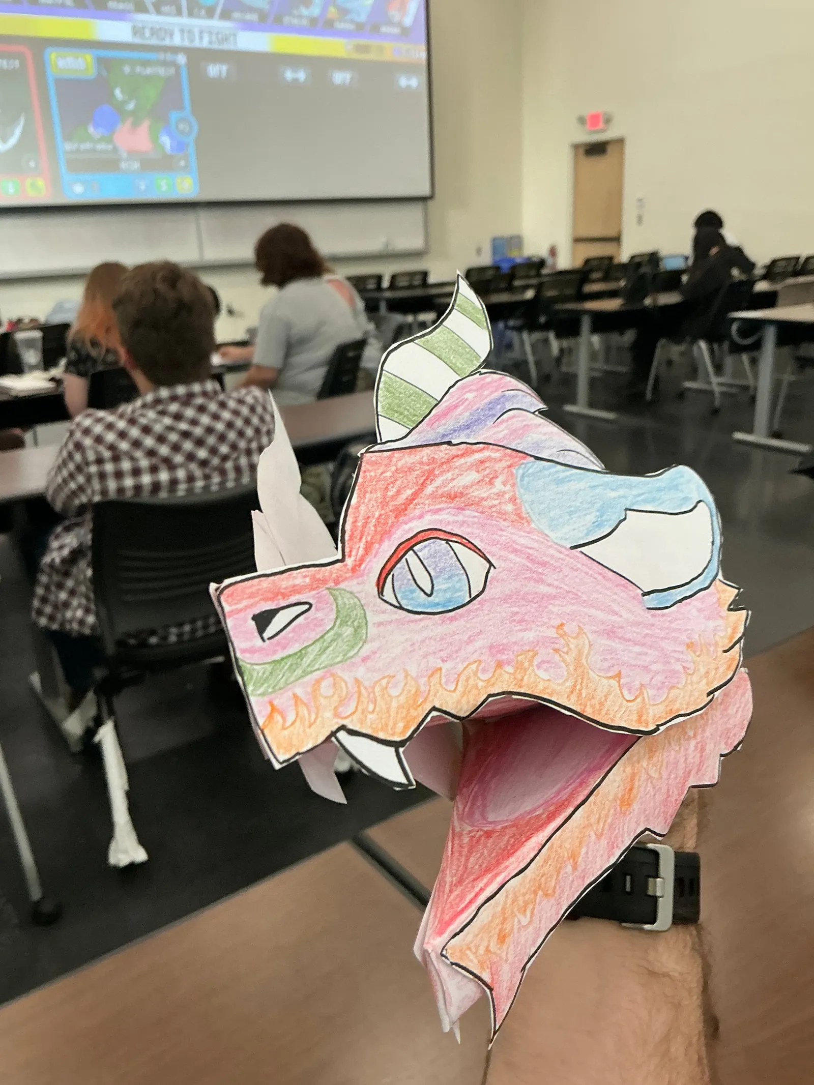 A handmade dragon hand puppet.