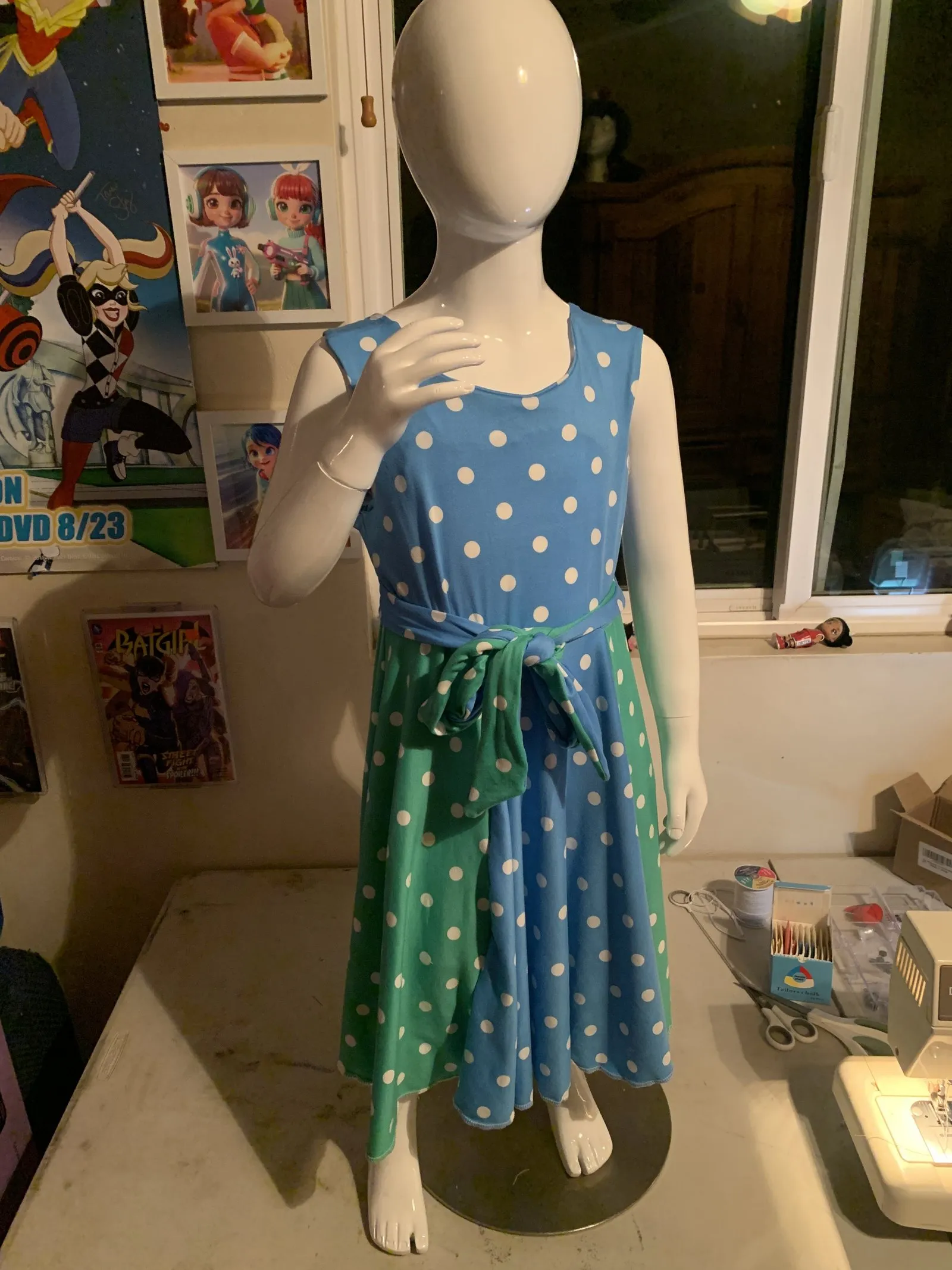 Annequin the Mannequin sporting a blue and green polka dress.