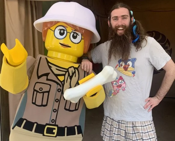 I didn’t know what to put here so this is a photo of me at Lego Land! I sometimes put colorful extensions in my pigtails, both of which have loose curls.